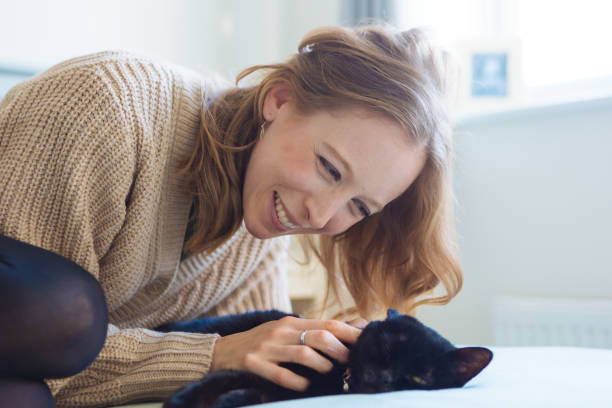 istock Woman pet owner cuddling with cat 2192233088