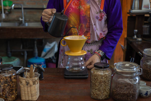 istock Process drip coffee, Barista start chose coffee bean and Roasting. Barista making drip coffee by pouring spills hot water on coffee ground with prepare filter from copper pot to glass transparent drip 2192233699