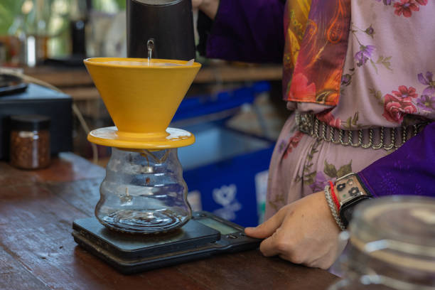 istock Process drip coffee, Barista start chose coffee bean and Roasting. Barista making drip coffee by pouring spills hot water on coffee ground with prepare filter from copper pot to glass transparent drip 2192233703