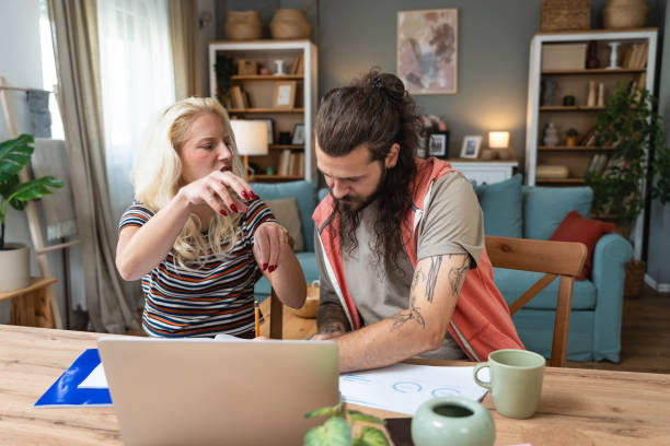 istock Confident couple office workers work at home, young caucasian couple sit at table using laptop computers for business project. Side hustle man and woman from apartment, finance and economy job. 2192234556
