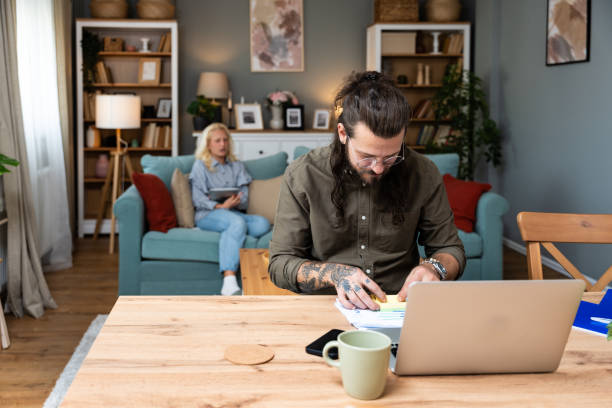 istock Confident couple office workers work at home, young caucasian couple sit at table using laptop computers for business project. Side hustle man and woman from apartment, finance and economy job. 2192234586