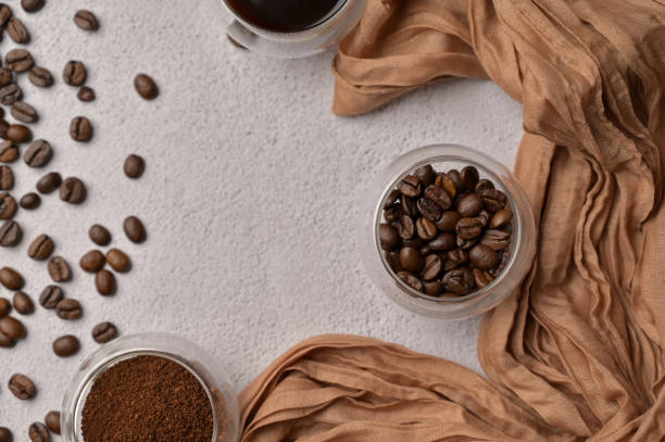 istock Top view fresh aromatic grain, ground and coffee drink in a small glasses, white background, brown cloth 2192235302