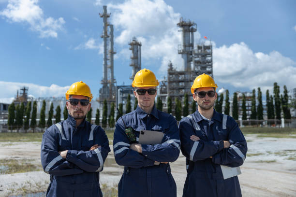 istock portrait of teamwork professional electrical engineer safety uniform each other together standing refining oil petrochemical industry. Technician worker at zone gas with refinery building background. 2192235527