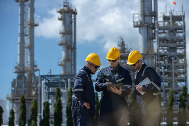 istock Engineer working using tablet together at station refining oil petrochemical. Technician worker check quality oil industry factory. Inspector standing at zone gas with refinery building background. 2192235548