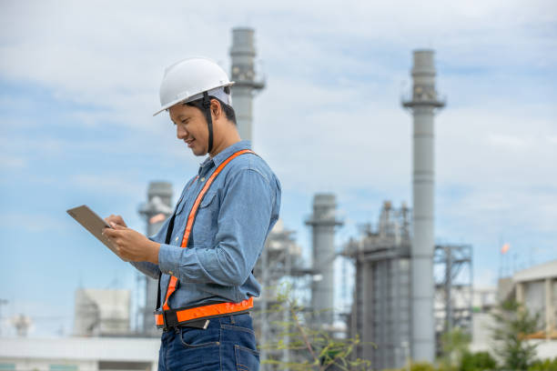 istock Engineer with tablet working factory producing electricity oil energy. Construction manager oil refinery in petrochemical. improvement inspector Industrial worker working power plant 2192235591