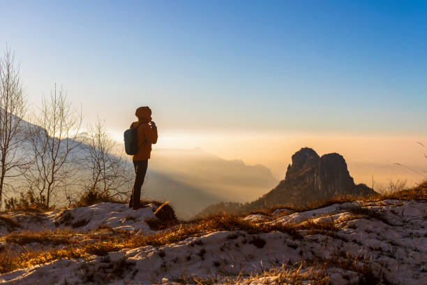 istock triumphant Moment in Nature: Mountain Explorer at sunrise 2192236797