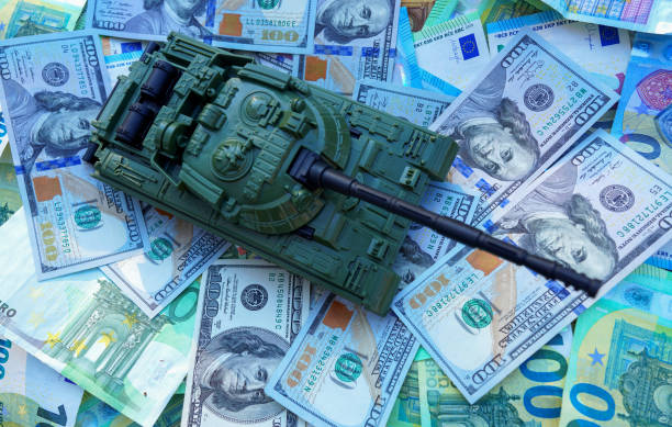 istock Tank on banknotes background. Currency war. War costs, military spending 2192237066