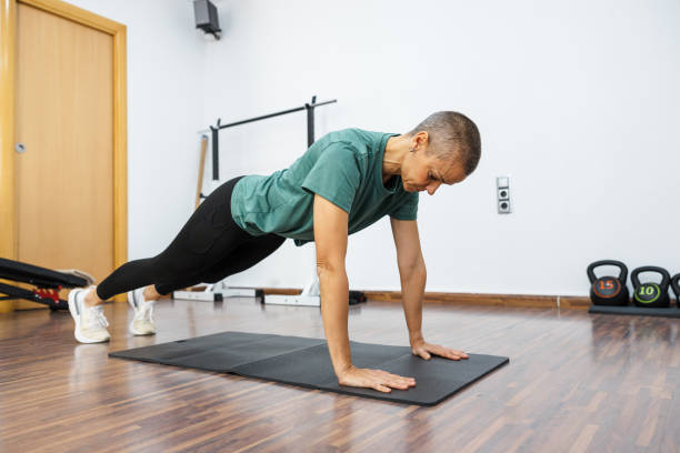 istock Determined woman performing plank exercise in home gym 2192237334