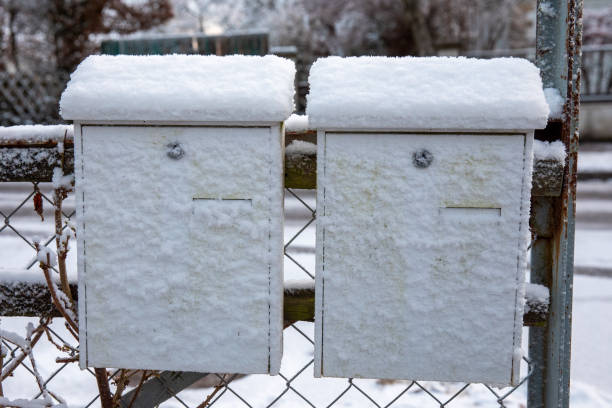 istock now-Covered German Mailboxes in a Picturesque Winter Scene 2192237469