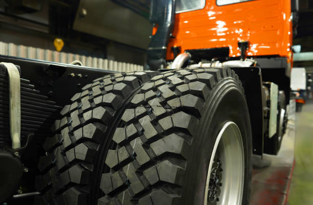 Truck Tires in Assembly line. Tires for Heavy duty trucks in lorry industrial plant. Tire tread of rubber wheel. Rubber tire for truck. New Tyres for lorry.  Assembly line truck factory. Manufacturing