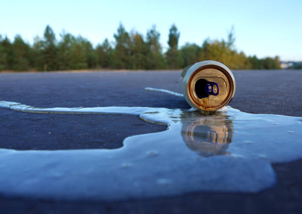 istock Crumpled beer can on asphalt with spilled alcohol. 2192238732