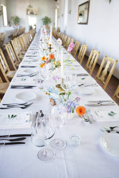 istock Banquet table in rustic European style. White tablecloth and empty glasses and plates. 2192241185