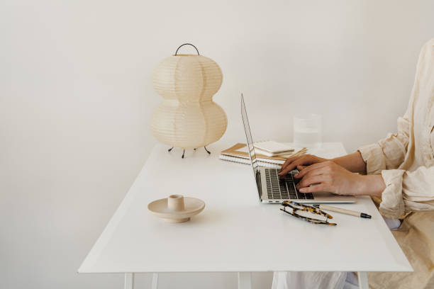 Person Typing on Laptop at Cozy Home Office Desk
