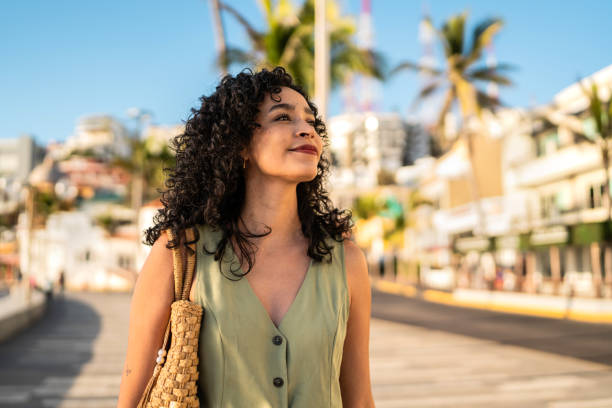 istock Young woman walking and looking around outdoors 2192247421