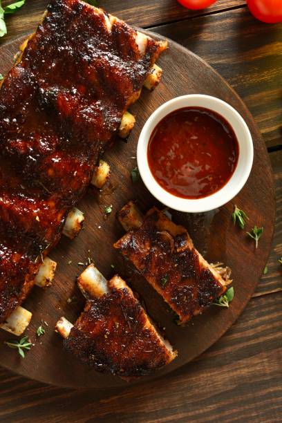 istock Barbecue pork ribs served with sauce on platter 2192247470