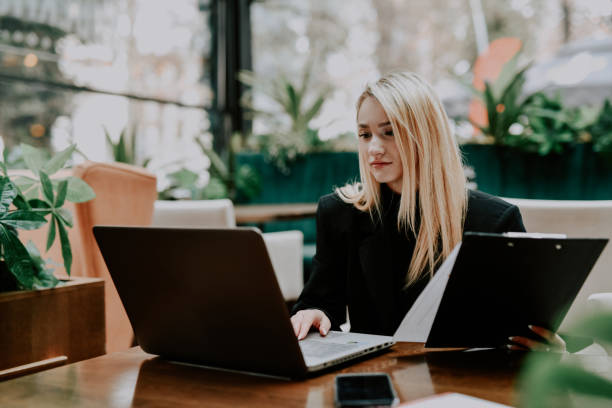 istock Busy Businesswoman Working From Modern Office Comparing Reports From Notepad and Laptop 2192247680