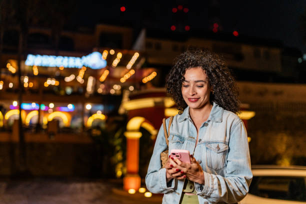 istock Young woman using mobile phone outdoors 2192247843