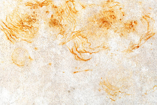 Dirty old tile with yellow brown stain.