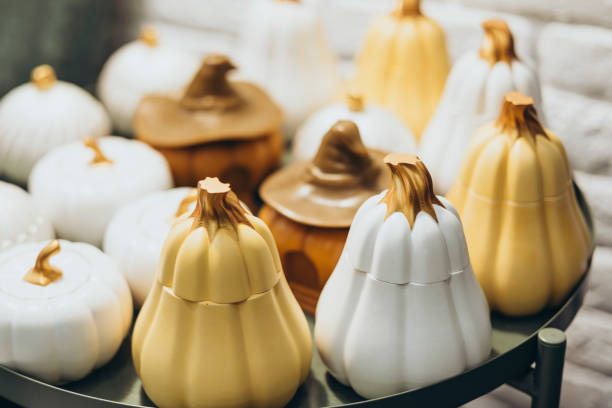 istock Handmade ceramic pumpkin candles in a cozy craft market. 2192248872