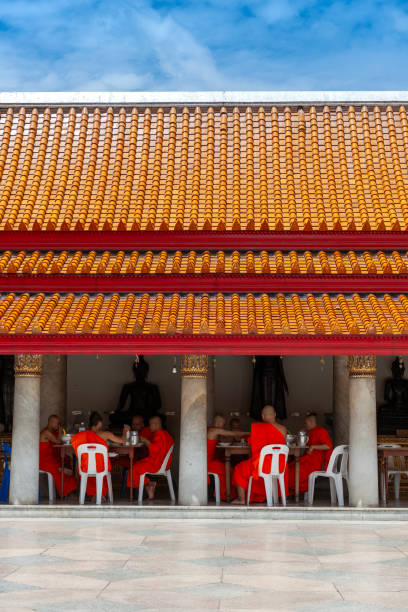 Buddhist monks having lunch in the Buddhist temple Wat Traimit. The Wat Traimit temple, located in the district of Samphanthawong Chinatown Bangkok, houses the world's largest solid gold Buddha statue.