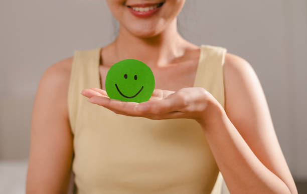 istock Green Smiley Face Mobile Phone Happy Good Feedback Positive Customer Reviews Experience Satisfaction Survey Smiley Mental Health World Mental Health Day 2192249552