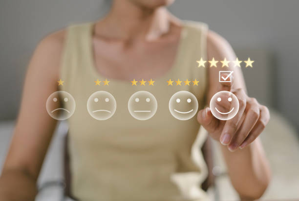 istock Close up of Asian customer. User presses with hand and five star icon on display screen for positive customer feedback, testimonials and confirmation. User comments and suggestions to make a review. 2192250083