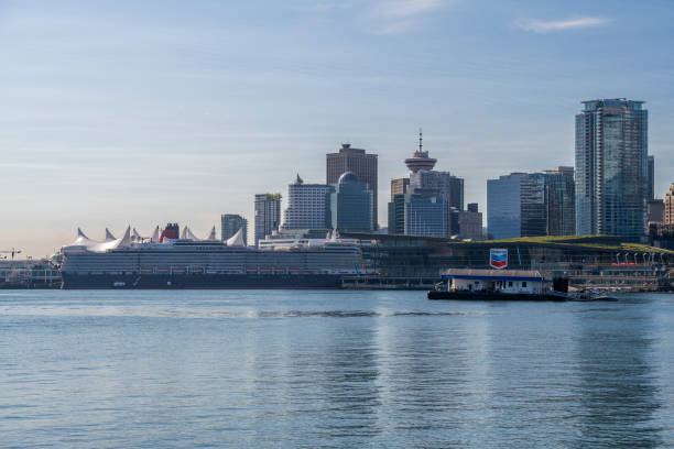 Vancouver city skyline seen from Stanley Park with Canada Place harbor and Queen Elizabeth cruise ship, British Columbia, Canada.