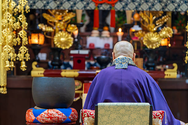 Image material of a monk praying at a Buddhist altar