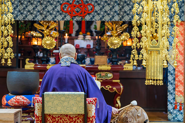 Image material of a monk praying at a Buddhist altar