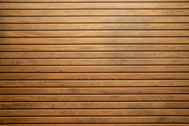 Ceramic wooden slatted panel with a natural texture and warm brown tones