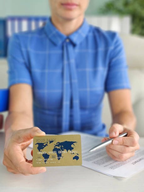 istock Holding a credit card while preparing to sign financial documents 2192253357