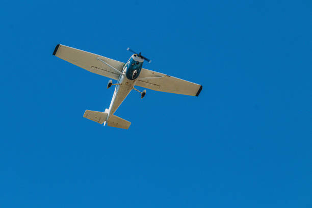istock A Light Aircraft Flying Gracefully Overhead in a Beautiful Clear Blue Sky Above Us 2192253531