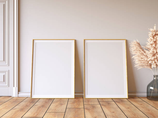istock Two Empty Mock Up Picture Frames on Parquet Floor Against White Wall 2192253924