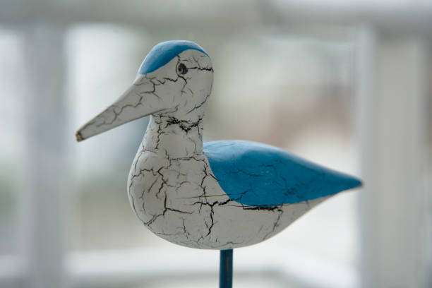 Coastal Charm: Blue and White Wooden Bird on Window Stand