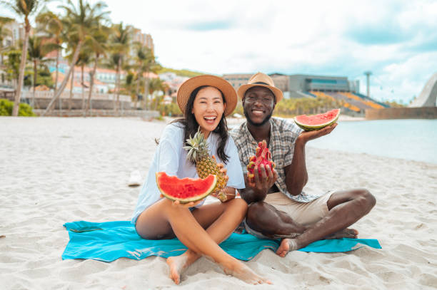 istock Diverse Couple Enjoys Watermelon on Beach 2192257941