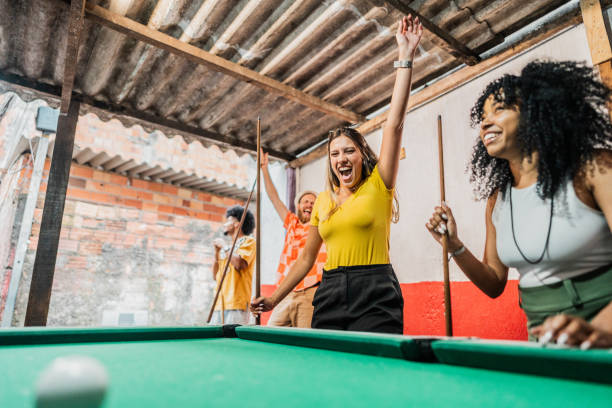 Friends playing in snooker bar in favela, Brazil