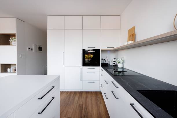 istock Modern Kitchen with White Cabinets and Black Countertop 2192260618
