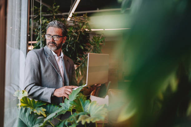 Businessman using laptop sustainable office
