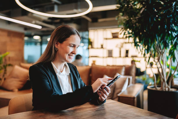 istock Businesswoman using smartphone at coworking workplace 2192261269