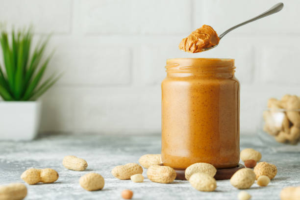 istock jar of peanut butter with levitating spoon 2192261524