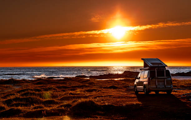 istock Camping car minivan on the beach at sunset Lofoten beach. 2192261588