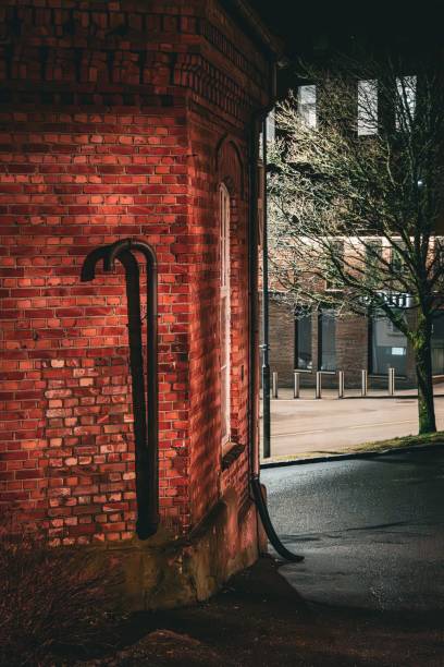 istock Red brick building at night with vertical pipes 2192261720