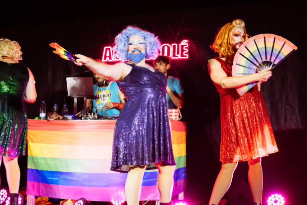 istock Drag queens performing on stage at pride event with rainbow flag and dj 2192262045