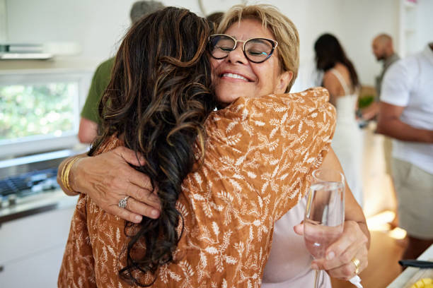 People hugging and greeting each other outdoors. Friends meeting, positive moments, bonding, togetherness