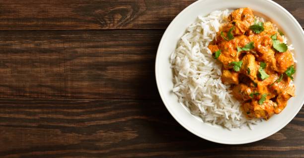istock Butter chicken with basmati rice on plate on wooden background 2192266826