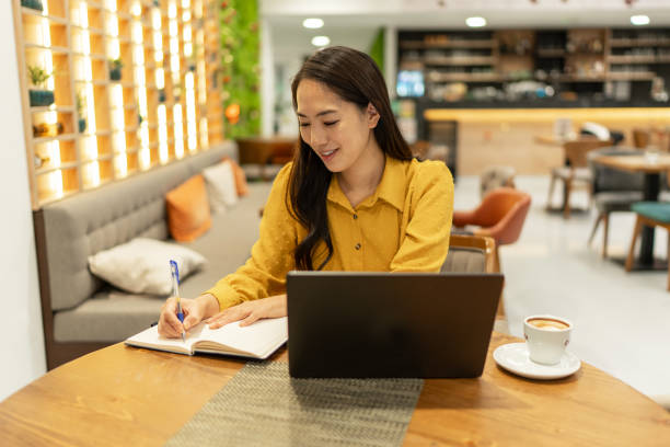 istock Businesswoman working on laptop at cafe 2192267902