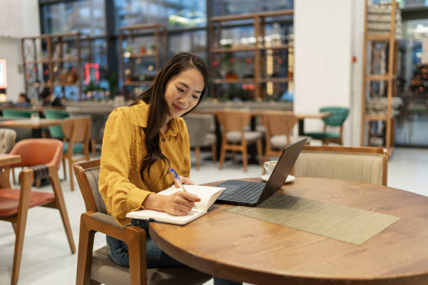 istock Businesswoman working on laptop at cafe 2192267949