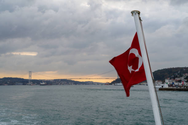 istock Turkish flag on a ship on the background of the Bosphorus Bridge 2192270477