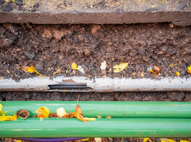 A section of street dug up for maintenance on damaged cable runs.