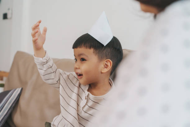 istock Cheerful young Asian boy wearing a paper hat 2192271230